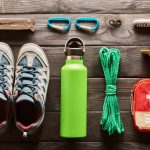 Travel items for hiking tourism flat lay still life over wooden background