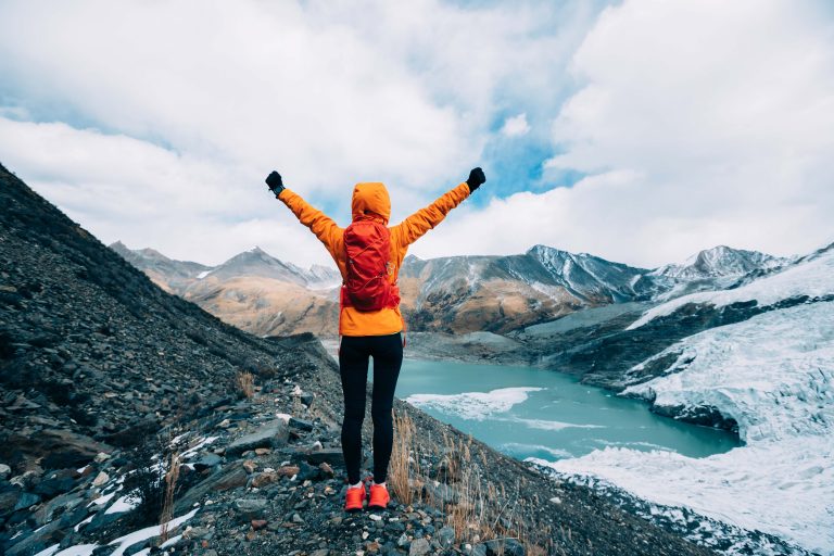 Woman hiker in high mountains winter